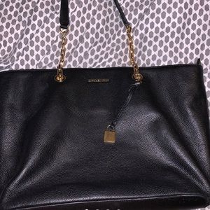 Big black Michael kors bag. Gold chain handles.